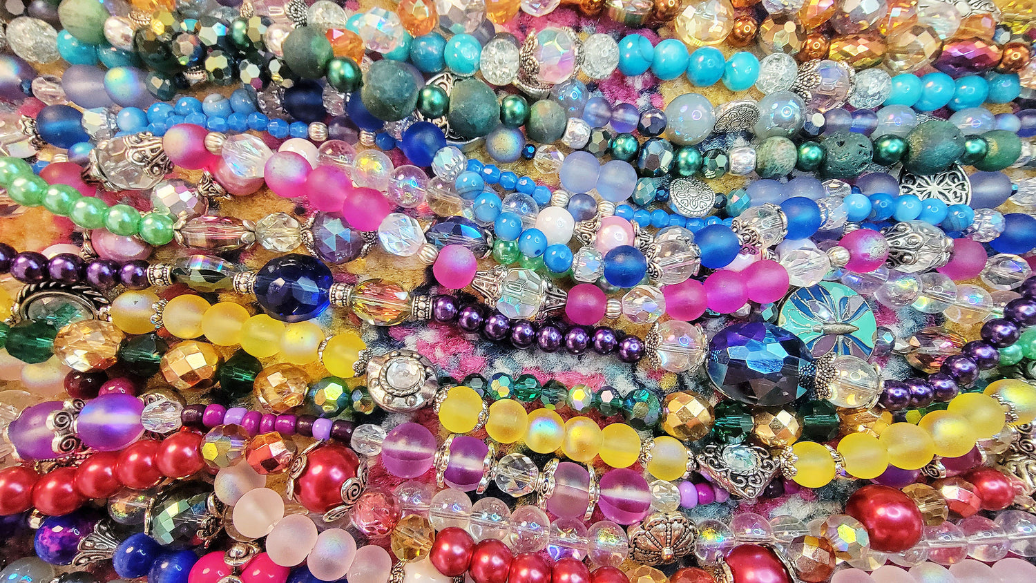 Strands of colorful necklaces lined up next to each other